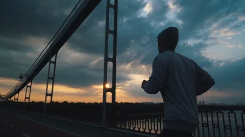Guy runs in the city in cloudy weather Stock Footage 117542615