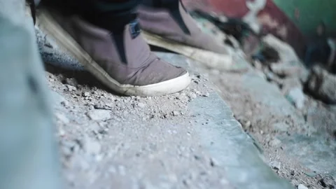 A guy runs down the stone steps. he's wearing sneakers on his feet Video stock 230193593