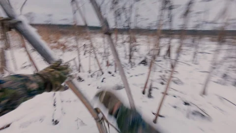 A guy runs into a field in winter through dry thickets of hogweed. Stock Footage 321354638