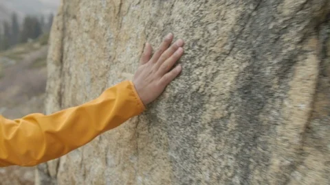 The guy runs his hand over the rock Stock Footage 107813004