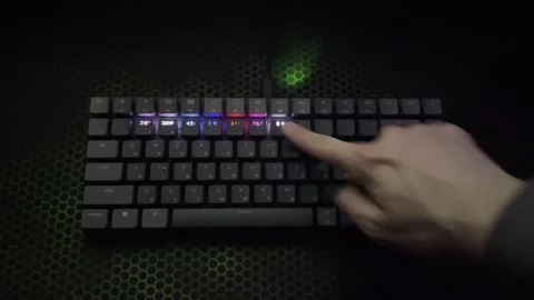 The guy runs his hand over the glowing keyboard Stock Footage 242395442