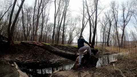The guy runs to the other side of the tree. Stock Footage 127640674