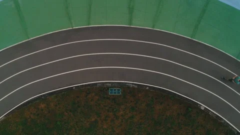 Guy runs in the stadium top view Stock Footage 117546111