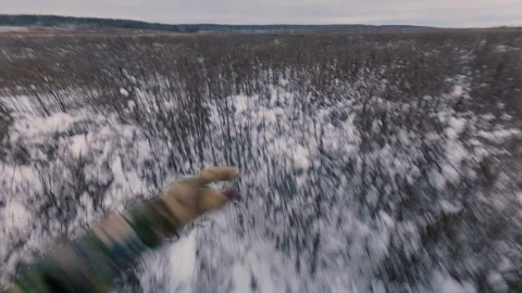 A guy runs through a winter field overgrown with dry grass. Stock Footage 321354495