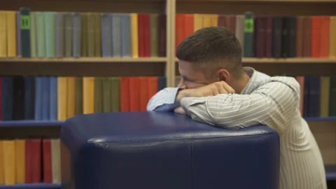 The guy is sad in the library Stock Footage 120177165