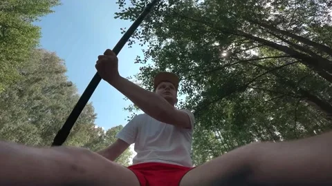 The guy is sailing on a SUP board and the camera looks at his face as he rows an Stock Footage 278508412