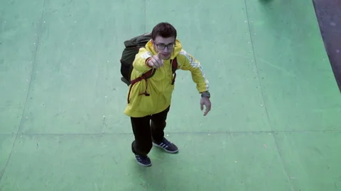 Guy says something to the operator and goes down the springboard Video stock 103650365