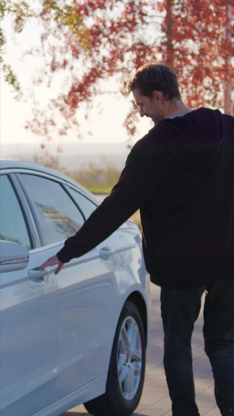Guy scans QR code on car windscreen and gets into vehicle Stock Footage 300547043