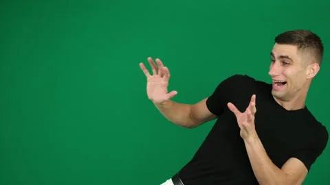 Guy scared to deviate horror. emotions of a handsome man guy on a green 스톡 동영상 278421233