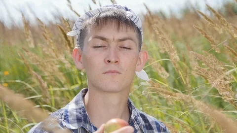 The guy with the Scarf on her Head Finds an Apple in the Box Stock Footage 85486889