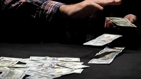 A guy scatters dollars with his hand at the camera close-up in slow motion. Stock Footage 129786450