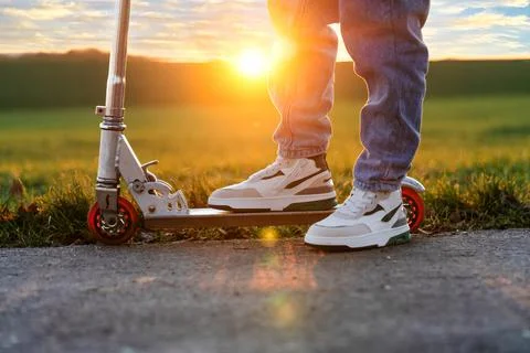 Guy on a scooter and at sunset Stock Photos