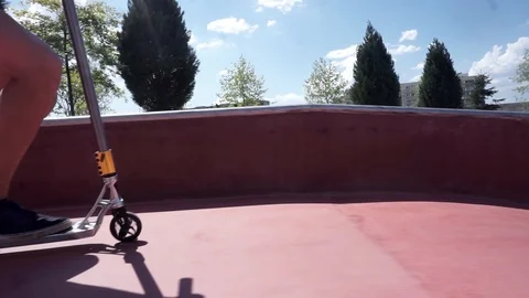 Guy on a scooter jumping on a slides in a skate park Video stock 102249188