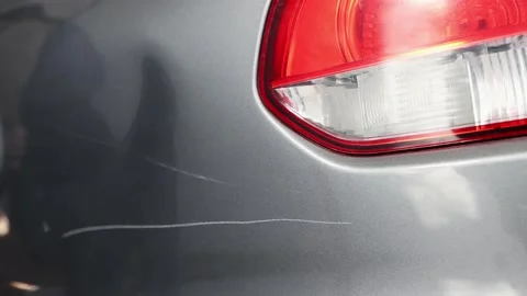 The guy scratches the car with a screwdriver and leaves the crime scene. Stock Footage 227375581
