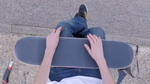 Guy is scratching a skateboard and greeting a friend 스톡 동영상 80554929