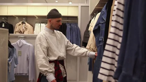 Guy is searching for clothes Stock Footage 265428719