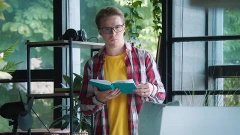 Guy searching details in notebook. Worker finding project keys. Serious focused Stock Footage 246560245