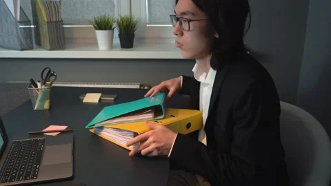 Guy Seating At Workplace Is Working With Documents Beginning of the workday Stock Footage 148344229