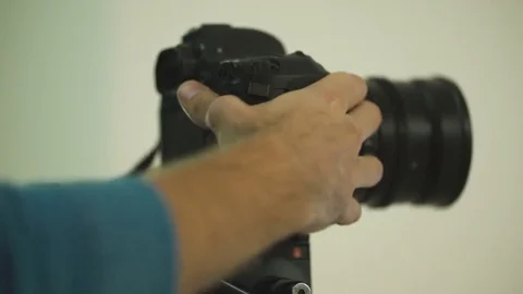 The guy sets up the camera to shoot the video. Stock Footage 84993814
