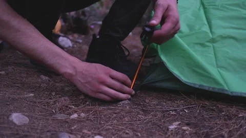 Guy sets up a tent in the mountains, close up shot of hands Stock Footage 200878388