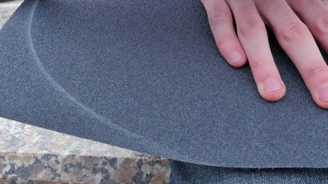 Guy sharpens the surface of the skateboard Stock-Footage 80553636