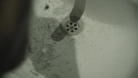 The guy shaves his beard with a trimmer in front of the bathroom mirror. Hair Stock Footage 131464963