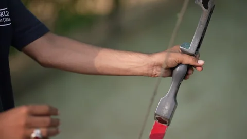 A guy shooting archery close up shot Stock Footage 246983912