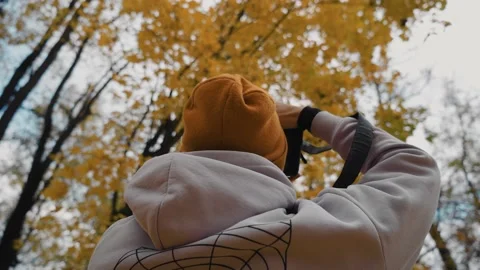 The guy shoots beautiful autumn trees on the camera Stock Footage 162833408