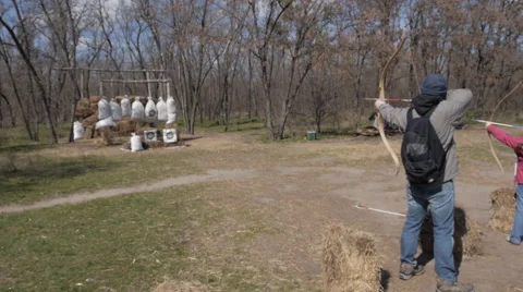 Guy shoots a bow 스톡 동영상 65408166