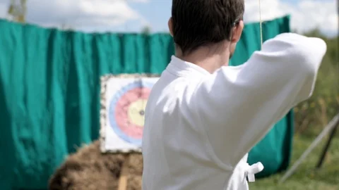 Guy shoots a bow at the target 스톡 동영상 104030507