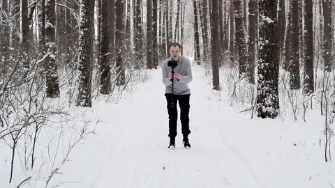 Guy shoots video with a stabilizer and a camera DSLR Stock Footage 84998500