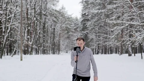 Guy shoots video with a stabilizer and a camera DSLR Stock Footage 85280235