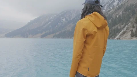 The guy on the shore of a mountain lake Stock Footage 107812945