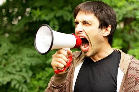 Guy is shouting into a bullhorn Stock Photos