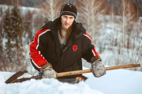 The guy with the shovel throws the snow Stock Photos