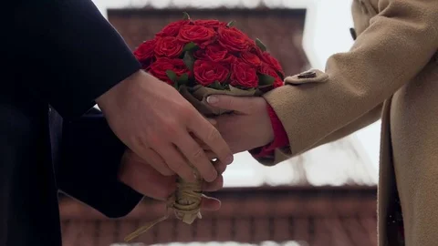 Guy showing his affection to girlfriend, presenting woman with bouquet of roses Stock Footage 83901185