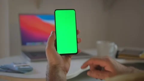 Guy is showing how easy to earn money with freelance green screen chroma key. Stock Footage 243474688