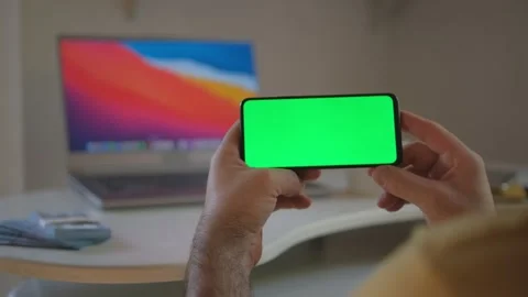 Guy is showing how easy to earn money with freelance green screen chroma key. Stock Footage 243509277
