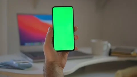 Guy is showing how easy to earn money with freelance green screen chroma key. Stock Footage 243661160