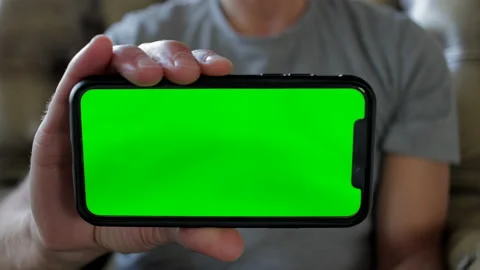 Guy showing mobile phone with green screen Stock Footage 220018148