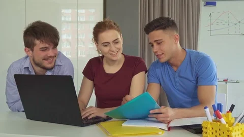 Guy shows colleagues something on blue folder Stock Footage 76625207