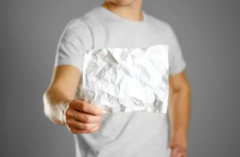 The guy shows crumpled clean notebook sheet in a cage Fotos Stock