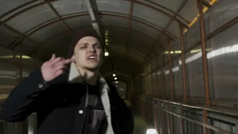 Guy shows different gestures to the camera and reads rap Stock Footage 80480374