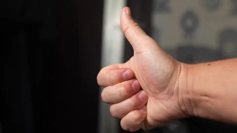 The guy shows two fingers on his hand, the piss symbol. Stock Footage 325641094