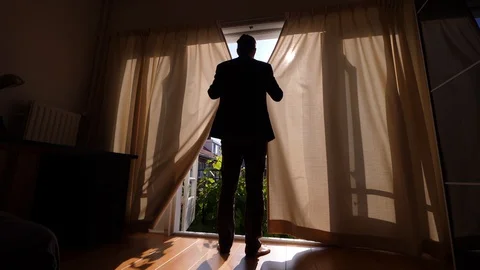 Guy shut drapes, close bedroom from sun light at late morning hour Video stock 128662371