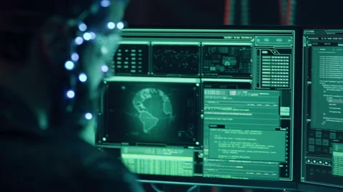 Guy side view with headset and mic develops code with multiple computer screens 動画素材 219348550