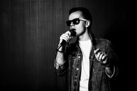 Guy Singing with Microphone. Black and White. Stock Photos