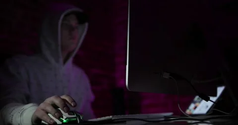 The guy sits in a dark room and uses his computer Stock Footage 132914910