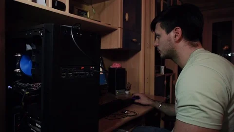 The guy sits at a disassembled system unit, a computer, works Stock Footage 121478127