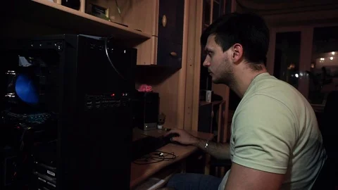 The guy sits at a disassembled system unit, a computer, works Stock Footage 121478145